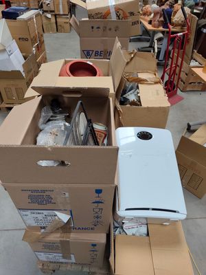 many cardboard boxes stacked on top of each other in a warehouse