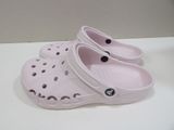 a pair of pink crocs that are on a table