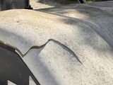 a crack in the roof of a truck that is parked in a lot