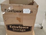 cardboard box on pallet with extra space self storage sticker on it