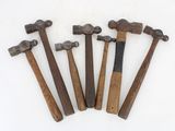 six hammers are lined up on a white surface with a white background