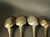 four spoons that are sitting next to each other on a table