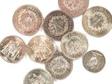 several british coins are arranged in a circle on a white surface