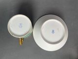 two cups and saucers are sitting on a table