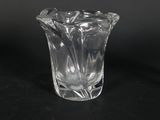 a small glass vase with a flower inside of it