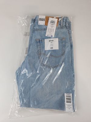 the back of a pair of jeans wrapped in plastic on a white surface