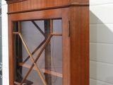 a wooden cabinet with a glass door on the outside