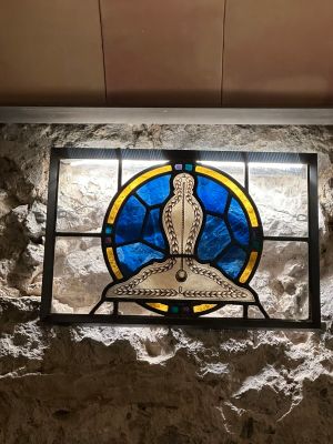 a stained glass window with a bird on it