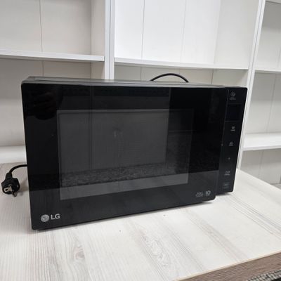 a black microwave sitting on top of a white counter