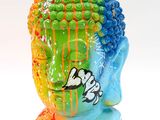a colorful statue of a buddha head on a white background