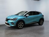 une voiture bleue garée dans une pièce aux murs blancs