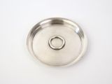 a silver plate with a ring on it on a white surface