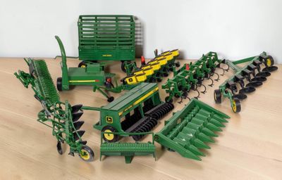 a lot of toy farm equipment on the floor