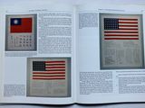 an open book with a picture of a flag and a page of text