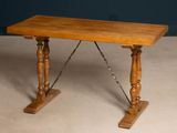 a small wooden table with a chain on it