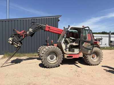 a tractor that is parked in front of a building