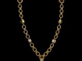a gold necklace with a cross pendant and a chain