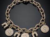 a gold bracelet with five coins and a cross on it