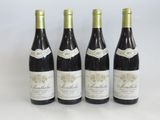 three bottles of wine are lined up on a table
