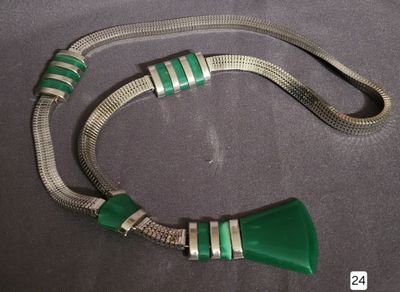silver and green necklace with a horn shaped pendant on a chain