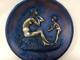 an image of a plaque with a woman and child on it