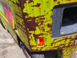 a close up of a forklift with a yellow paint job on it