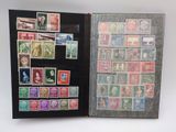 an open book with a lot of stamps on it sitting on a table