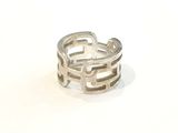 silver plated ring with two inter links on a white background