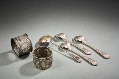 five silver spoons and two silver spoons on a table