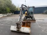 a small excavator that is sitting in the parking lot