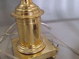 a golden lamp that is on a table with a cord