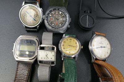 a lot of watches that are sitting on a table