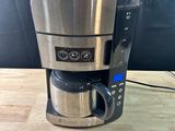 a coffee maker that is sitting on a wooden table