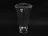 a glass vase that is sitting on a black background