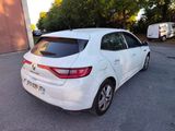 the rear end of a white car parked in a parking lot