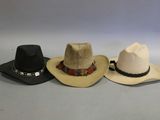 three hats are lined up in a row on a table