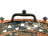 a large black and orange bowl with designs on it