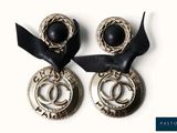 deux paires de boucles d'oreilles ornées d'un ruban noir sur un fond blanc
