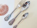 three spoons and two spoons on a table