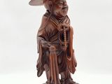 an image of a statue of a man wearing a hat and holding a cane