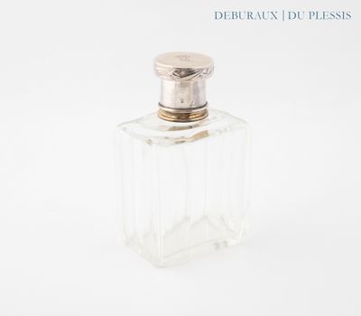 a bottle of perfume sitting on a white surface