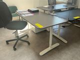 a desk with two chairs and a computer on it