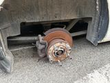 a rusted tire with a flat tire on the ground