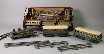 several toy trains are lined up in a box on a white surface
