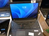 Plusieurs ordinateurs portables sont posés sur une table, avec des étiquettes de prix dessus.