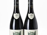 two bottles of wine sitting next to each other on top of a table