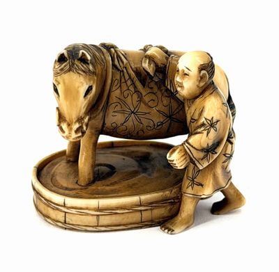 a figurine of a man with a baby on a horse