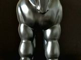 a silver statue of a horse on a marble base