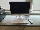 a computer on a desk with a keyboard and mouse