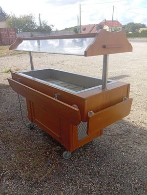 a wooden table with a glass top sitting on the ground